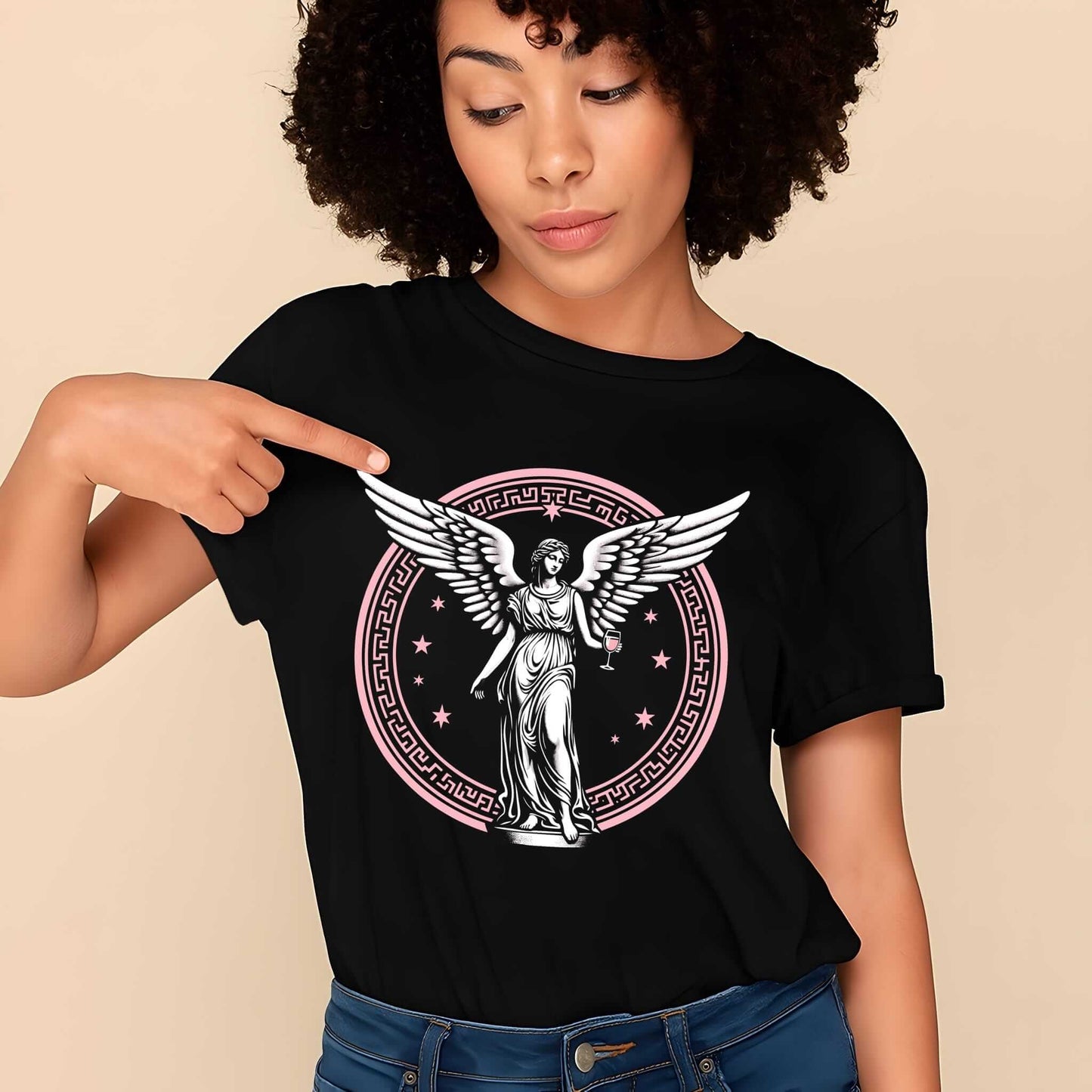 Black t-shirt featuring a striking beige-toned graphic of angel with wings, enclosed in detailed celestial circle with stars.