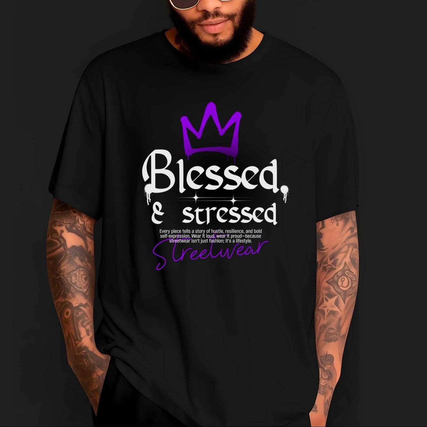 Blessed & Stressed text with a purple crown icon and streetwear script below, white and purple lettering on a black t-shirt.