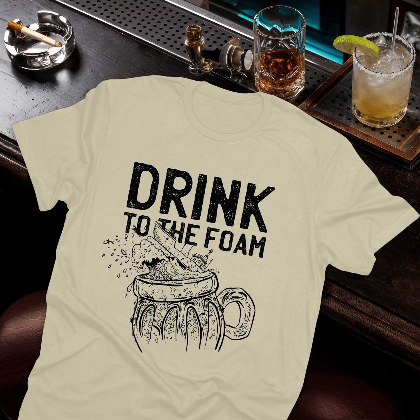 Retro beer lover tee featuring bold "Drink to the Foam" slogan with sketched beer mug and frothy foam design