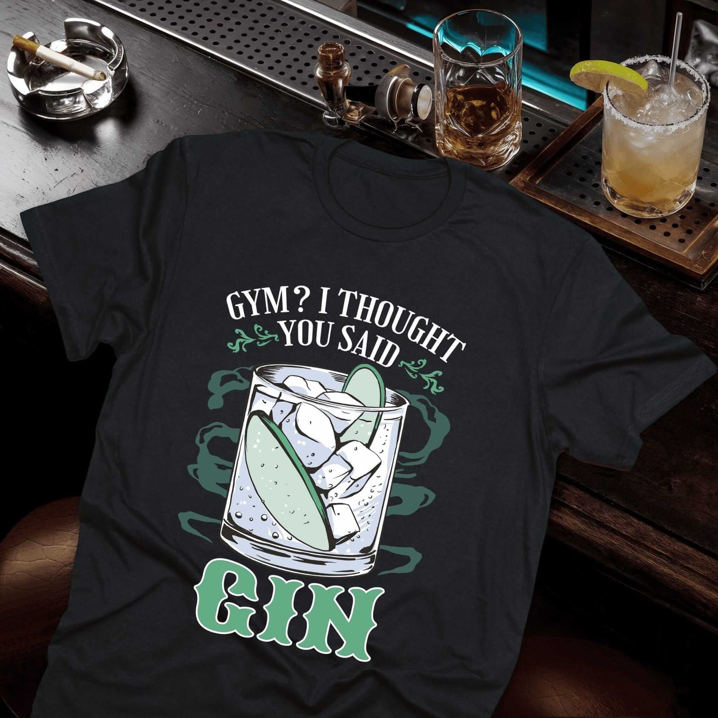 Black t-shirt with "Gym? I Thought You Said Gin" text and cocktail glass with light green lime slice illustration