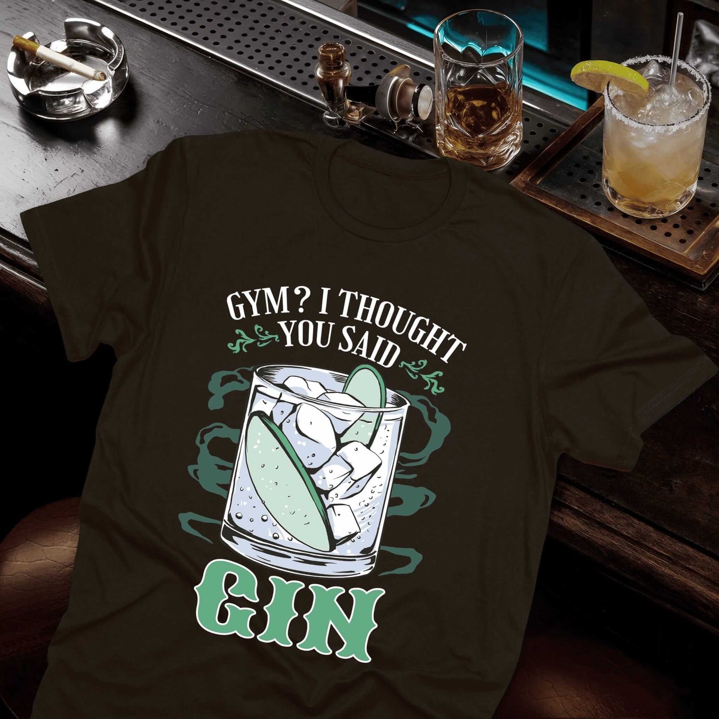Brown-colored t-shirt featuring gin and tonic illustration with "Gym? I Thought You Said Gin" comedy saying
