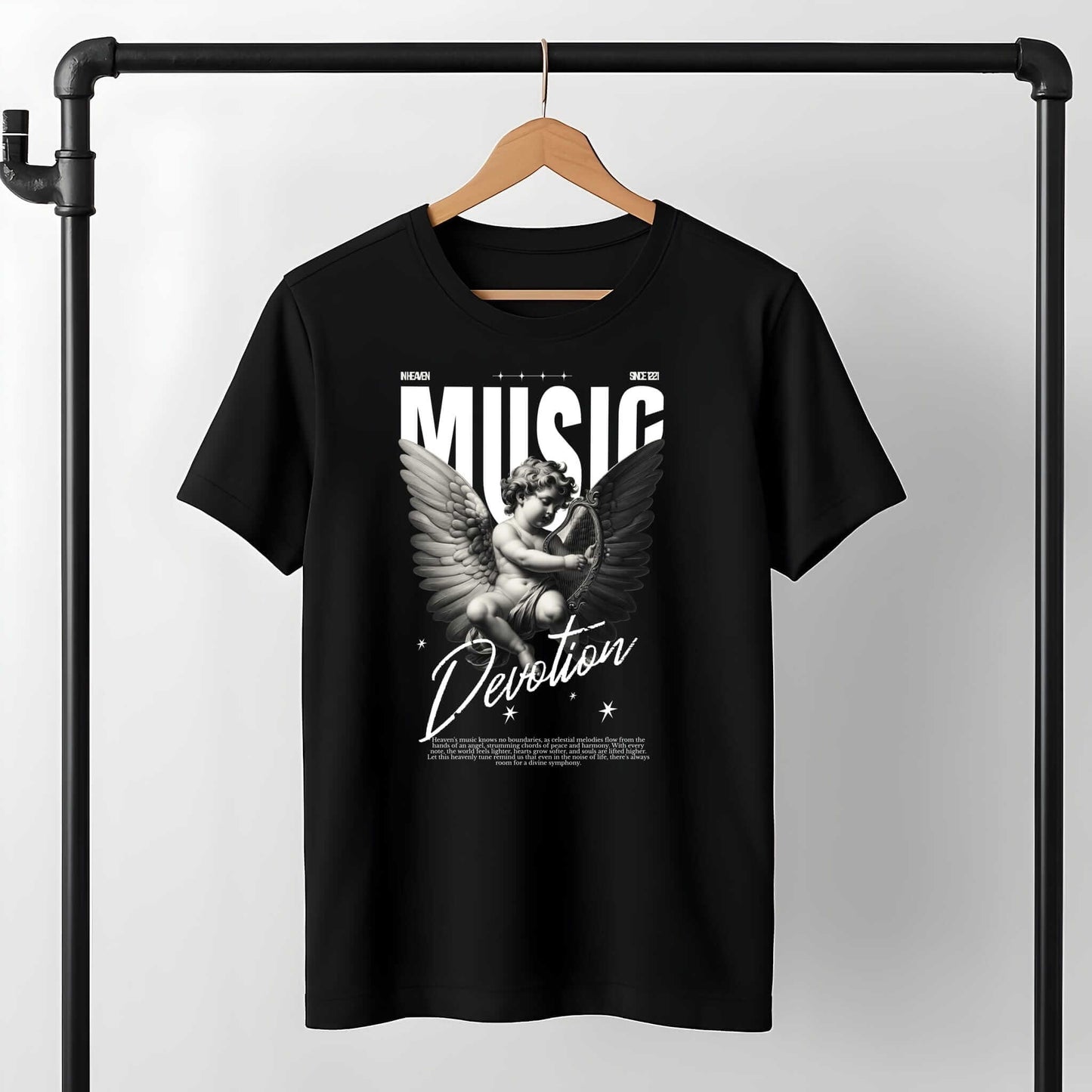 Black tee with white "MUSIC" text, winged angel figure, and "Devotion" script lettering with decorative stars
