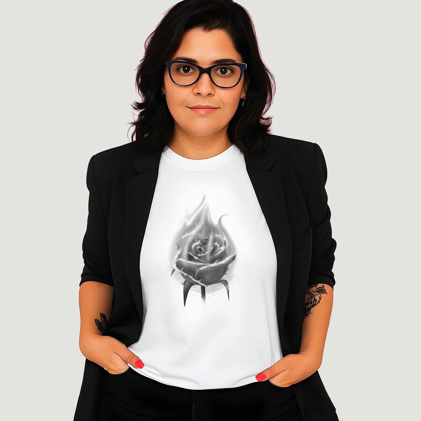 Monochrome spray-painted rose with realistic petals and misty overspray effects in black and gray tones on the white t-shirt.
