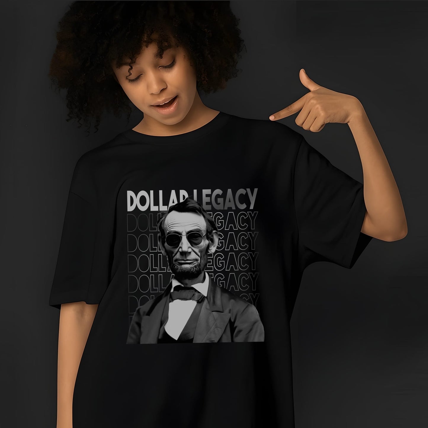 Black t-shirt featuring Abraham Lincoln portrait with sunglasses and bold "DOLLAR LEGACY" text in white lettering design