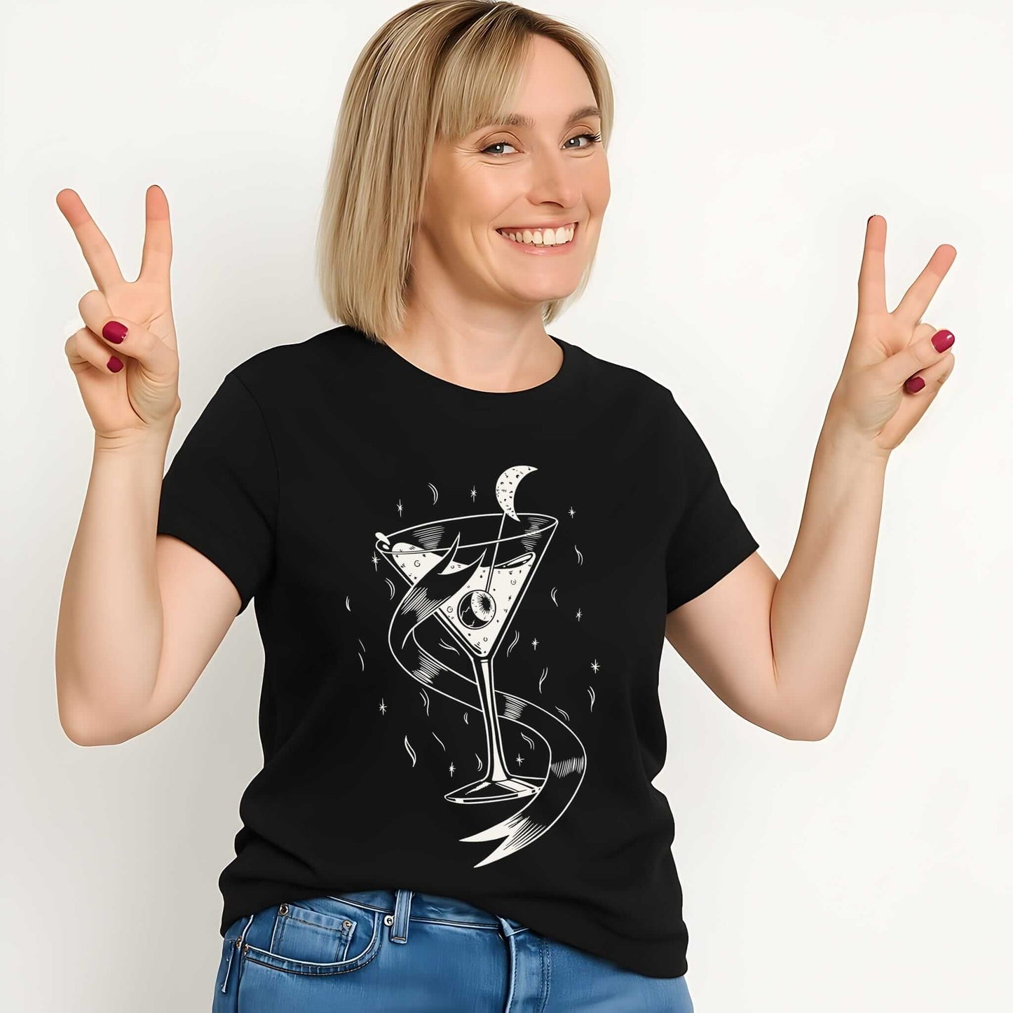 White line art cocktail glass with crescent moon and flowing ribbon elements on black women's t-shirt