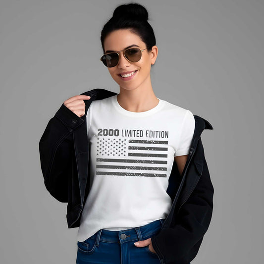 Distressed American flag with weathered stars and stripes below "2000 LIMITED EDITION" text on a white cotton t-shirt.