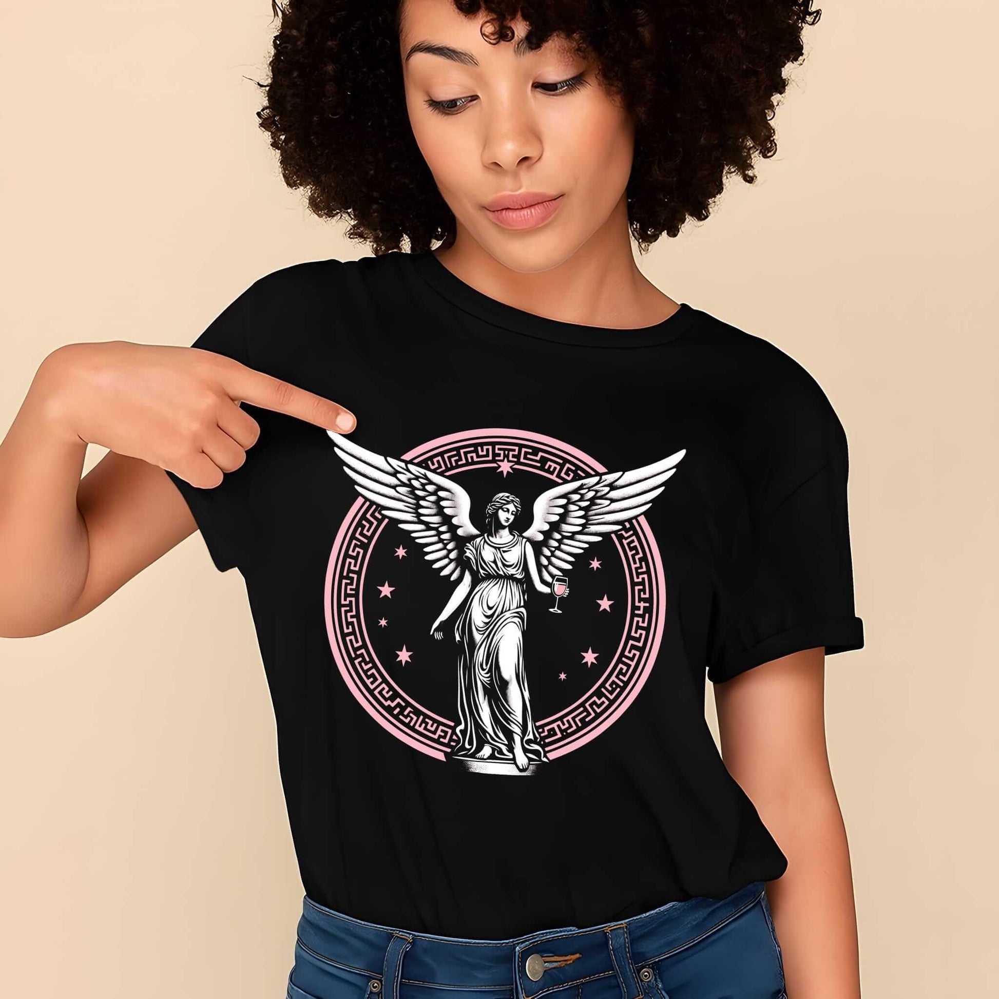 Black t-shirt featuring a striking beige-toned graphic of angel with wings, enclosed in detailed celestial circle with stars.