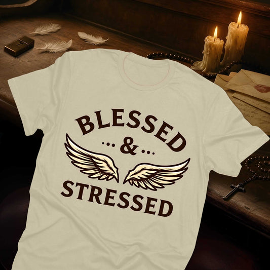 Beige shirt featuring "BLESSED & STRESSED" typography in brown with artistic wing design creating visual balance