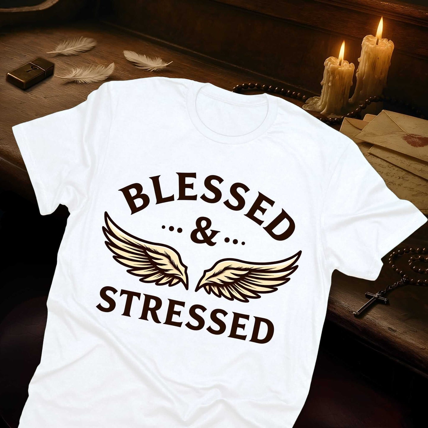 Classic white t-shirt displaying "BLESSED & STRESSED" text in rich chocolate brown with a graceful angel wings design element