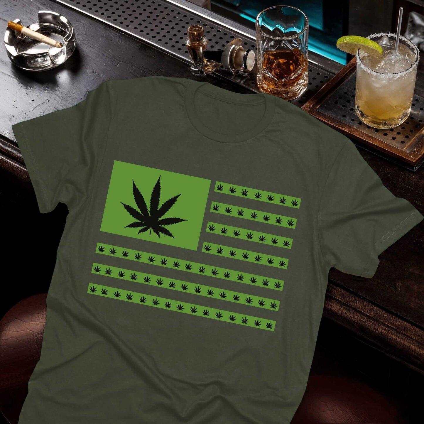 Military green t-shirt featuring an American flag design made of green cannabis leaves replacing stars and stripes.