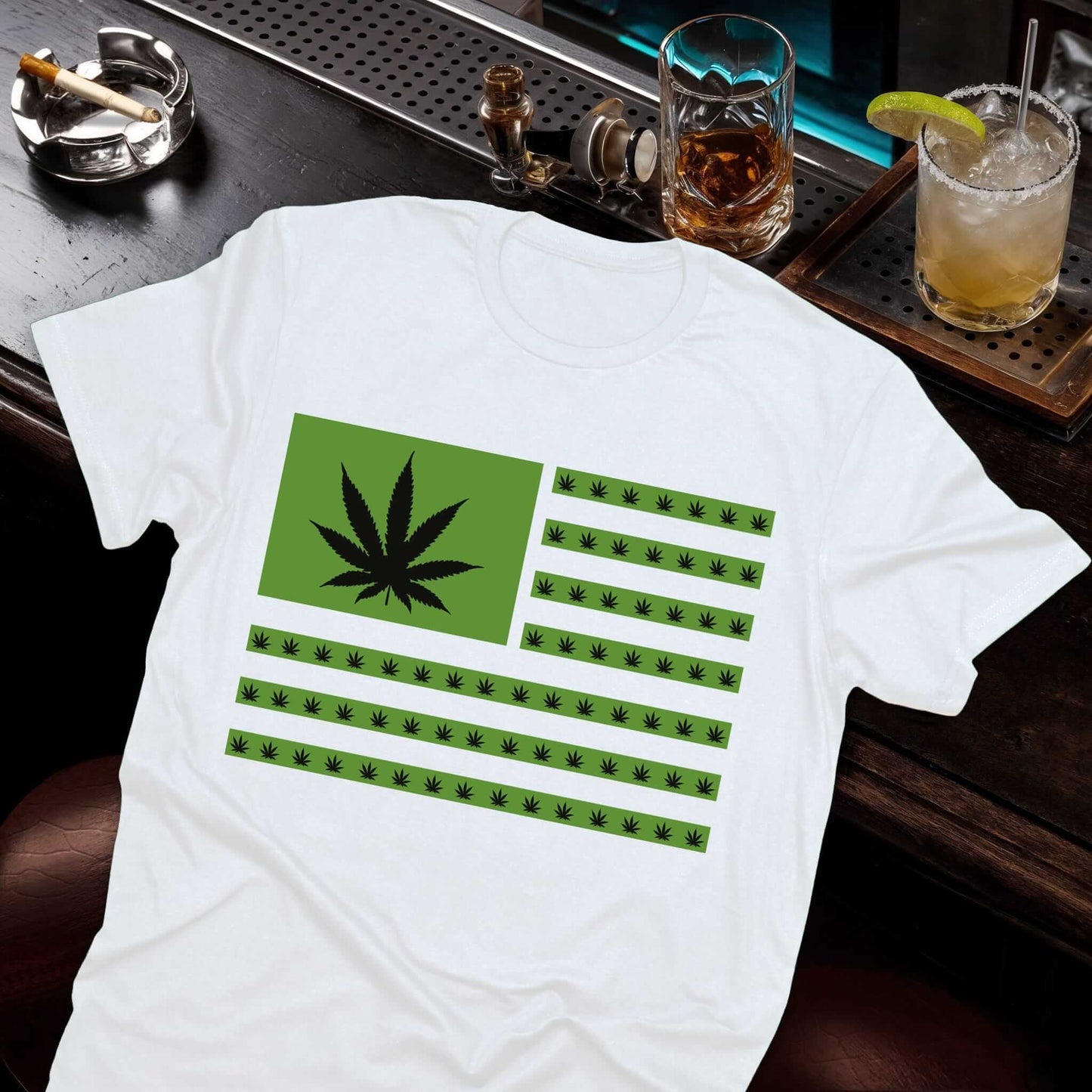 White t-shirt featuring an American flag design with green cannabis leaves replacing the stars and stripes.