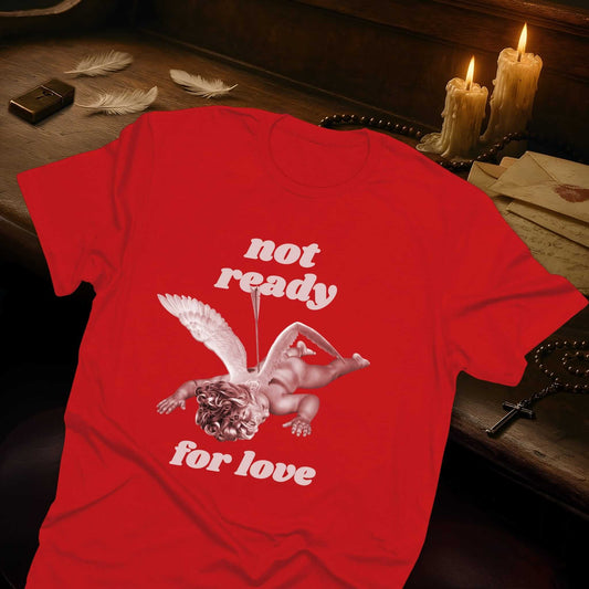 Red t-shirt with "Not ready for love" text and a cupid with an arrow pierced through it, lying face down with wings spread