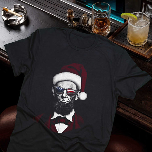 Abraham Lincoln t-shirt graphic showing the president in a Santa hat and red bow tie with playful Christmas styling
