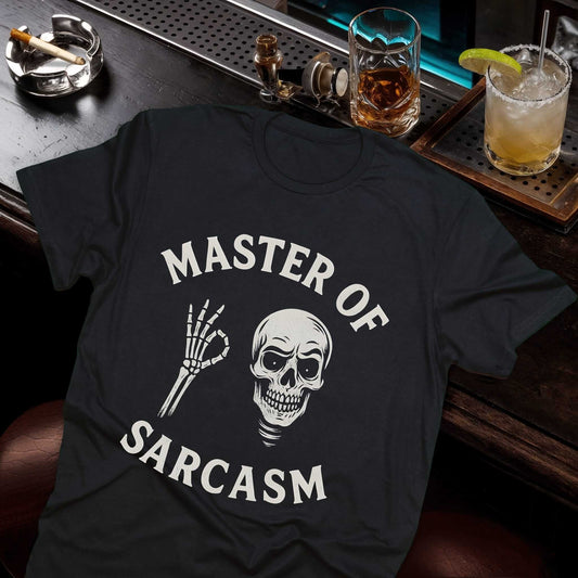 "Master of Sarcasm" text with grinning skull and skeleton hand making OK gesture on black cotton tee, bold white graphics