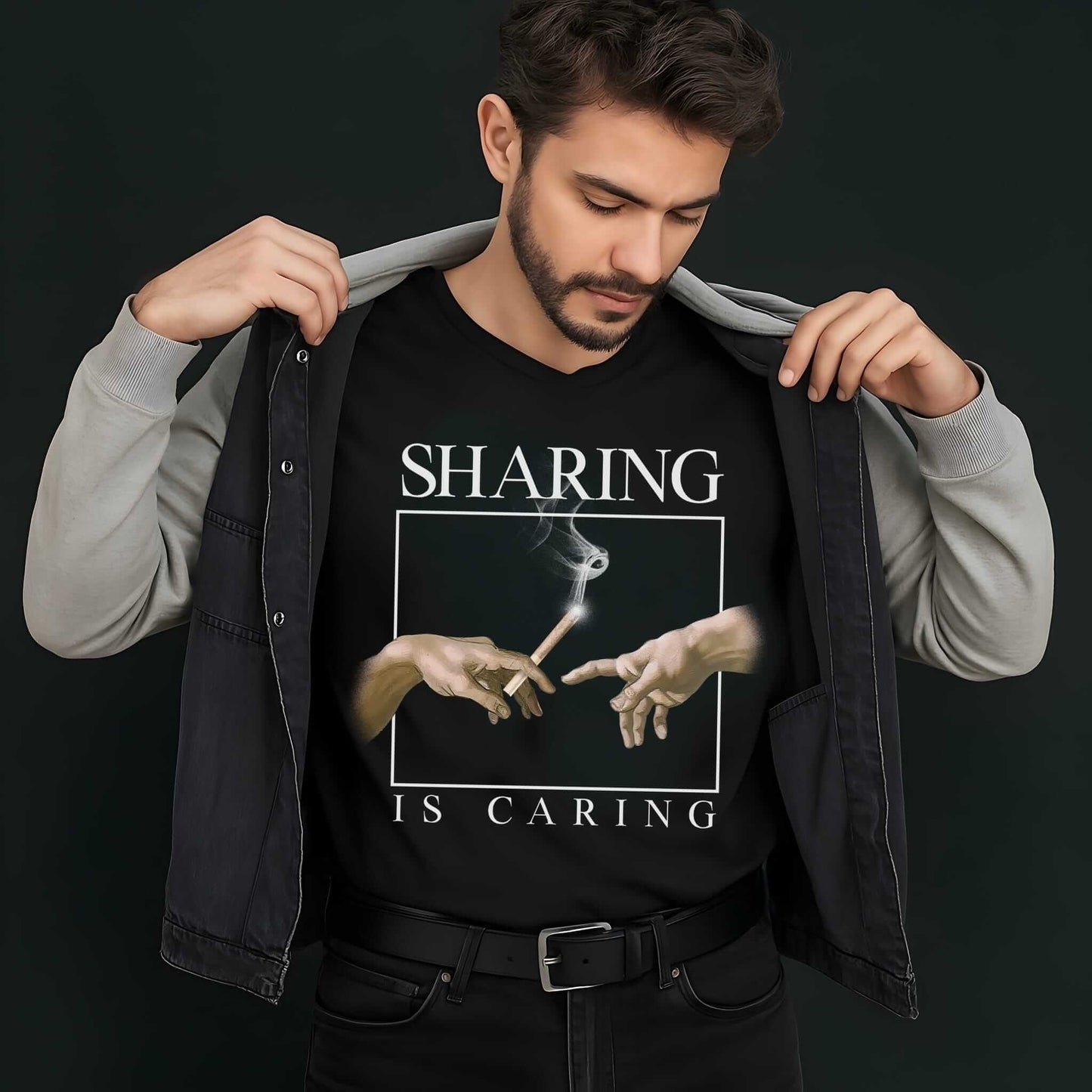 Sharing Is Caring design featuring Michelangelo's Creation hands reaching for a cannabis leaf on a black t-shirt.