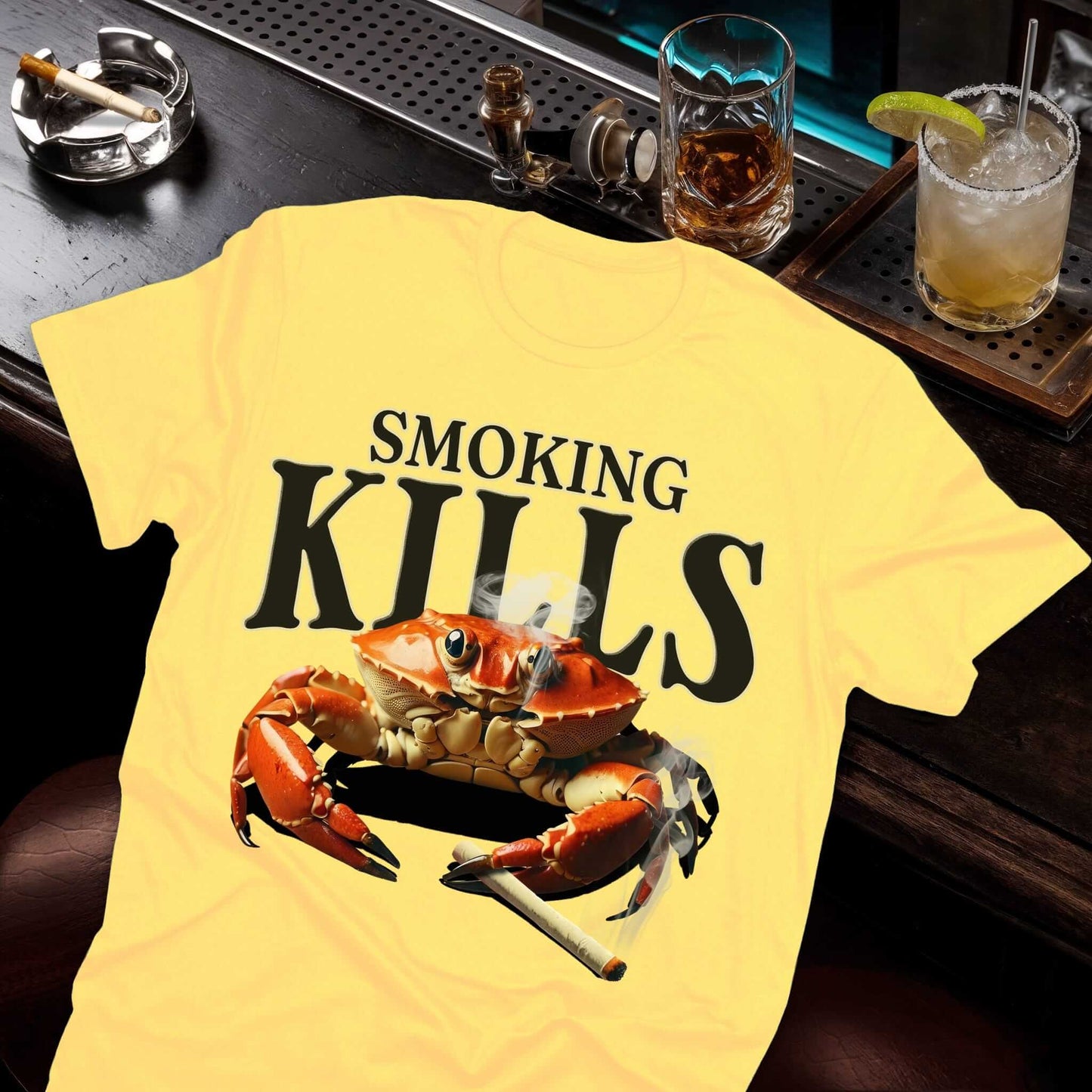 "SMOKING KILLS" text on yellow t-shirt, above realistic crab holding cigarette, by Vice & Tees' Hazy Vice collection design
